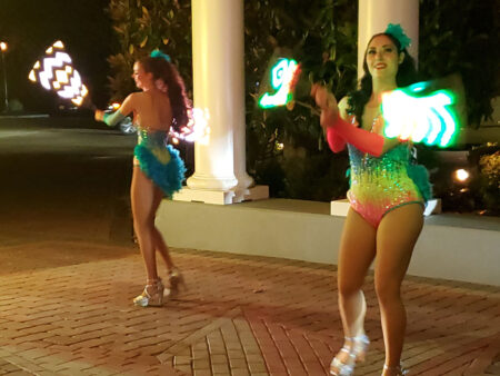 two women performing a light show